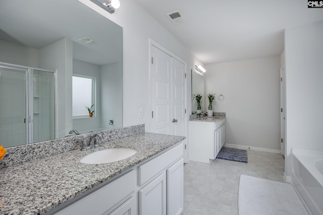 bathroom featuring vanity and a shower with door