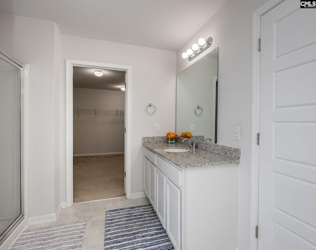 bathroom featuring vanity and a shower with shower door