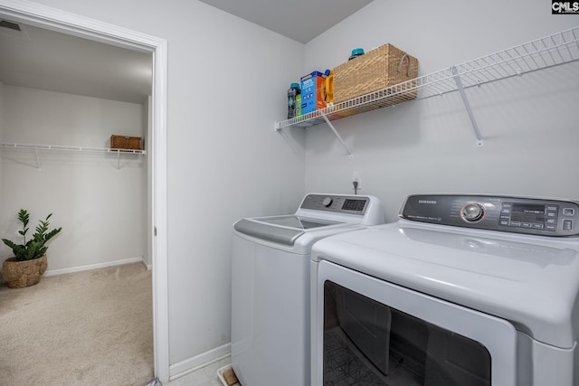 washroom with light colored carpet and washing machine and dryer