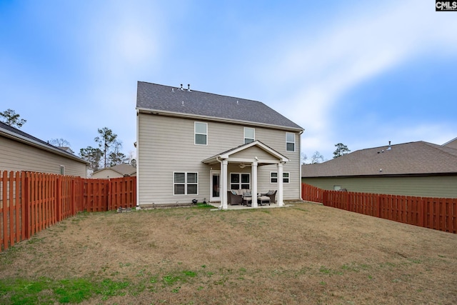 back of property with a patio and a lawn