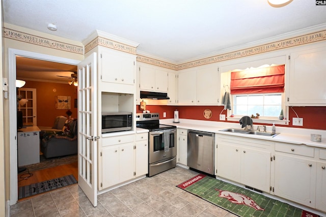 kitchen with sink, crown molding, white cabinets, and appliances with stainless steel finishes