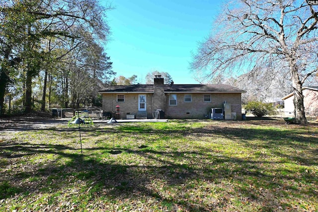 back of property with a yard and a patio