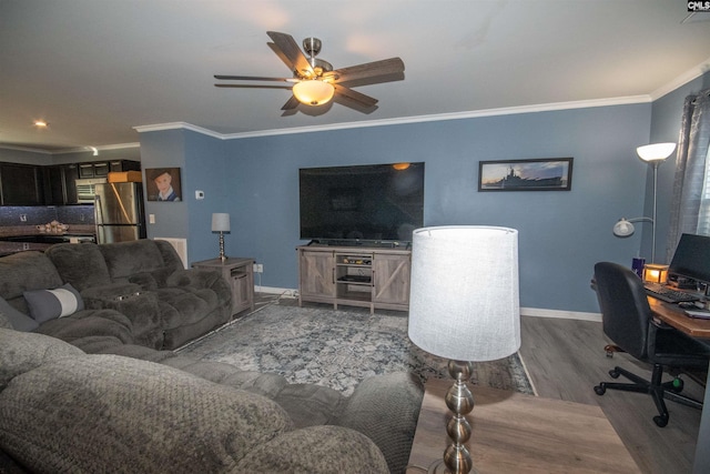 living room with hardwood / wood-style flooring, ceiling fan, and crown molding