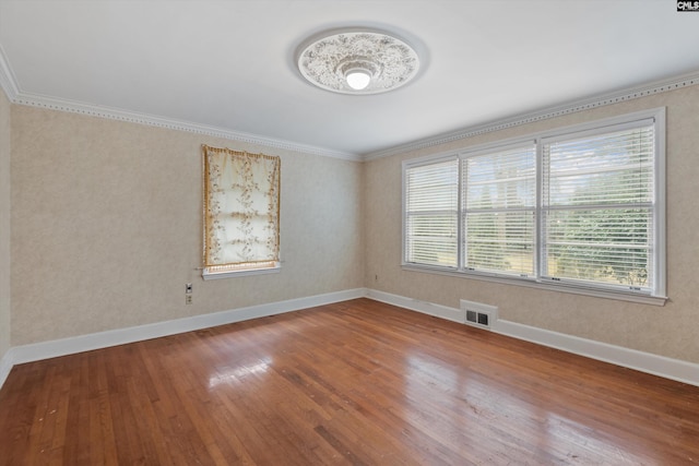 spare room with hardwood / wood-style flooring and ornamental molding