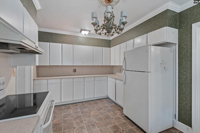 kitchen with white cabinets, a chandelier, crown molding, wall chimney range hood, and white appliances