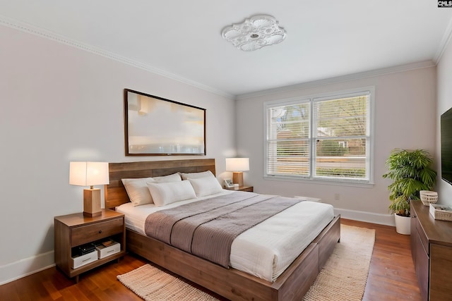 bedroom featuring crown molding and dark hardwood / wood-style floors