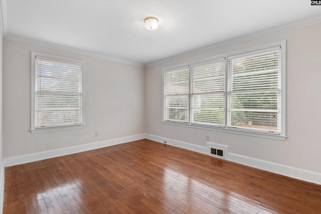 empty room with wood-type flooring and ornamental molding