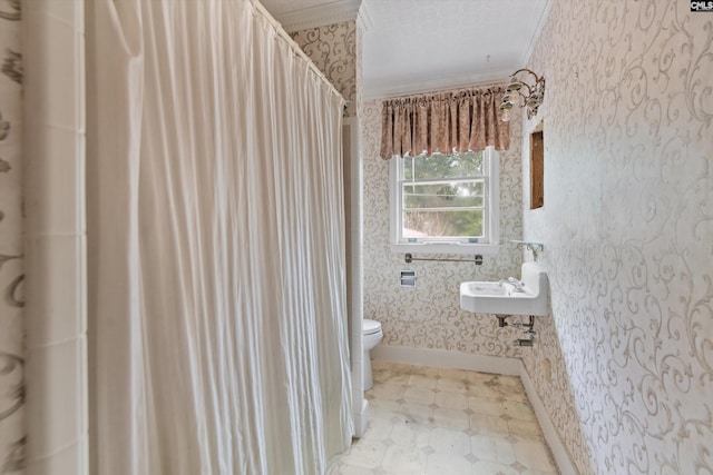 bathroom with crown molding, sink, a textured ceiling, and toilet