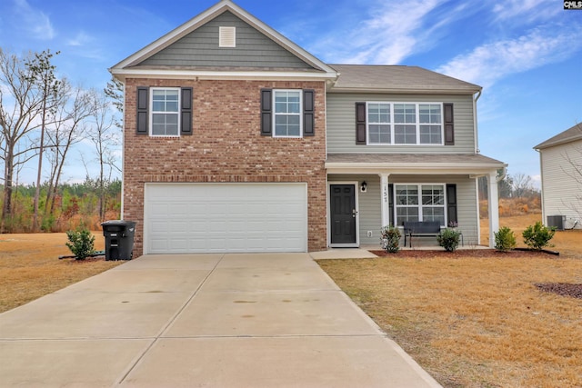 view of front of property featuring a garage, a front yard, and central air condition unit