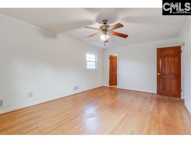 unfurnished room featuring ornamental molding, ceiling fan, and light hardwood / wood-style floors