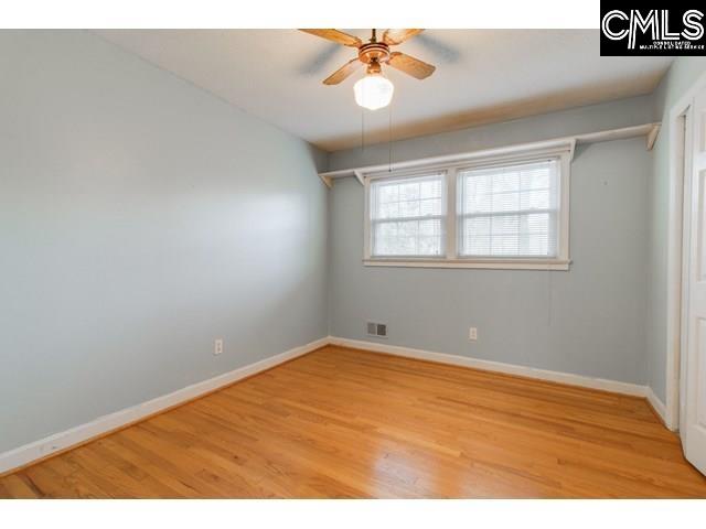 unfurnished room with ceiling fan and light wood-type flooring