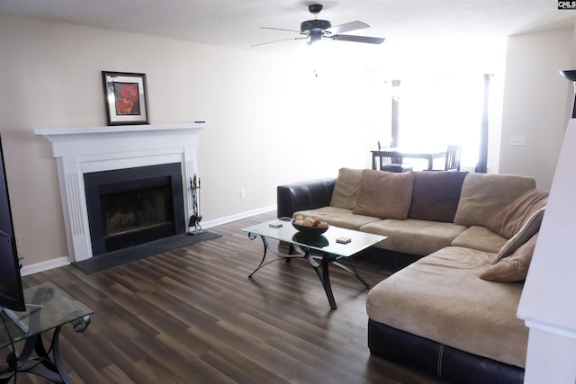 living room featuring dark wood-type flooring and ceiling fan