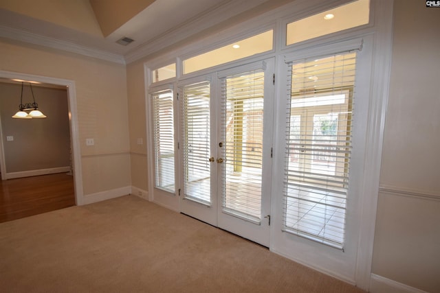 doorway to outside featuring ornamental molding, carpet, and french doors