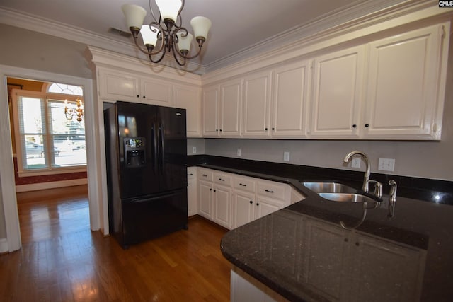 kitchen featuring sink, white cabinetry, an inviting chandelier, black fridge with ice dispenser, and decorative light fixtures