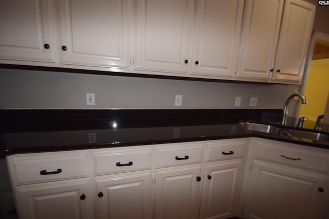 kitchen featuring sink and white cabinets