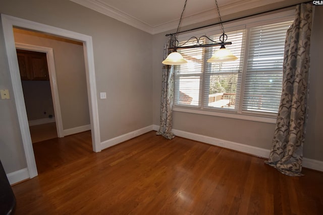 unfurnished dining area with ornamental molding and hardwood / wood-style floors