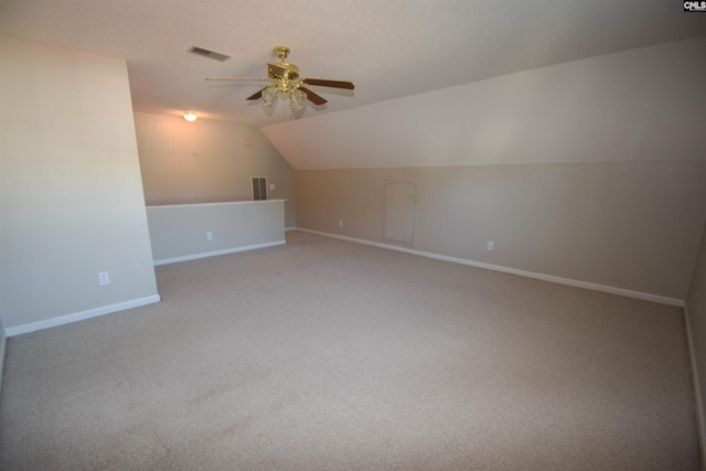 bonus room featuring vaulted ceiling, carpet flooring, and ceiling fan