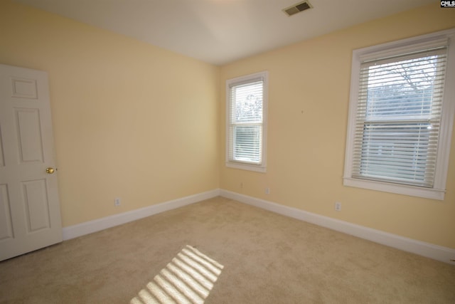 unfurnished room with light carpet