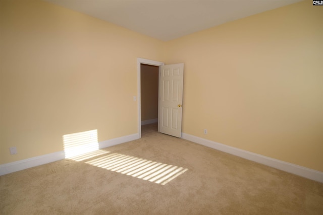 unfurnished room featuring light colored carpet