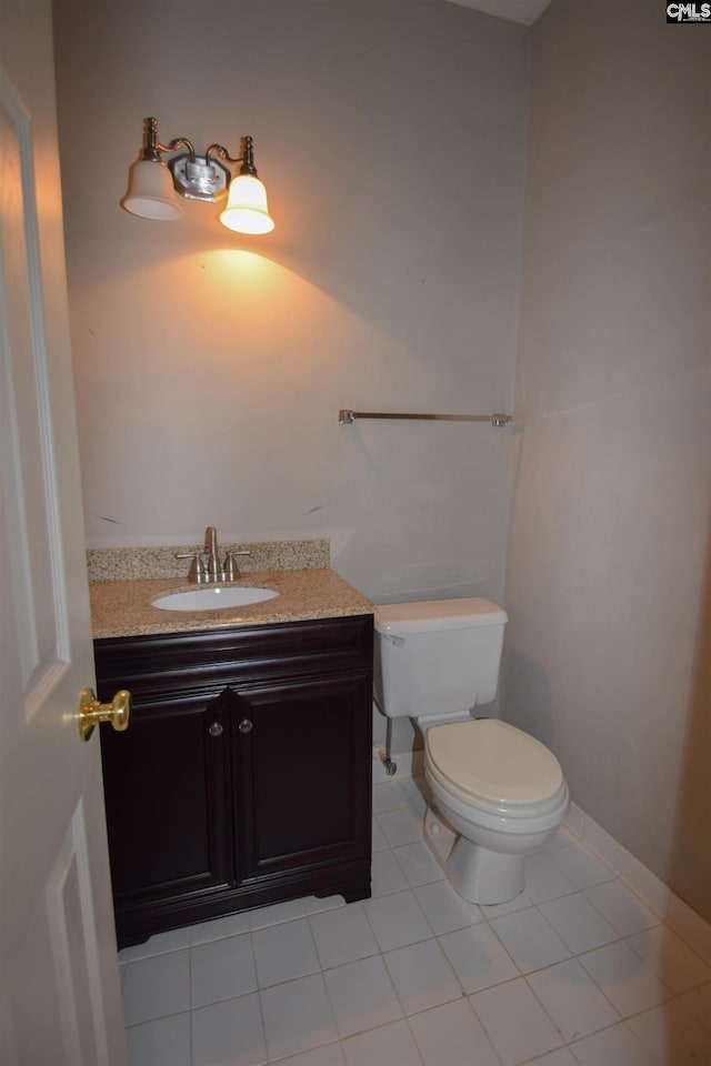 bathroom with vanity, tile patterned flooring, and toilet