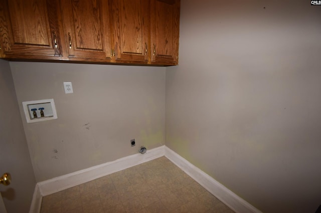 clothes washing area featuring cabinets, hookup for an electric dryer, and washer hookup