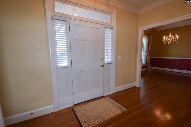 entrance foyer featuring ornamental molding, wood-type flooring, and a notable chandelier