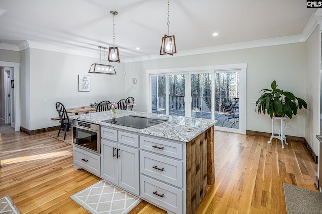 kitchen featuring ornamental molding, light stone countertops, light wood finished floors, and black electric cooktop