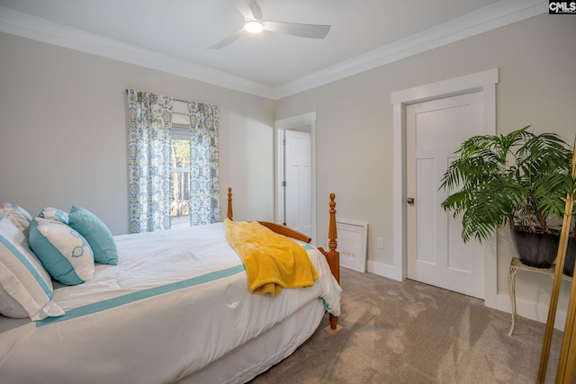 carpeted bedroom featuring ornamental molding, baseboards, and a ceiling fan