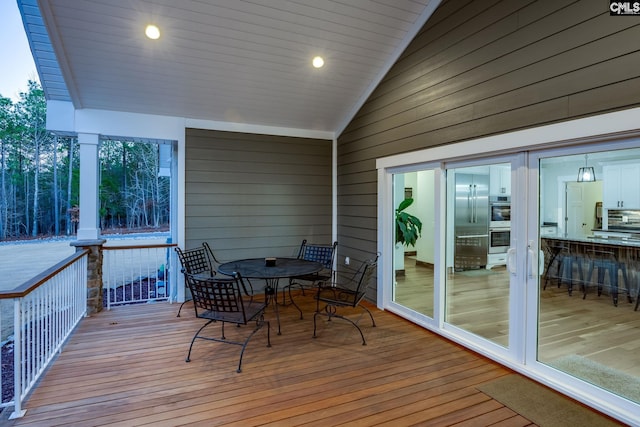 wooden deck featuring outdoor dining area