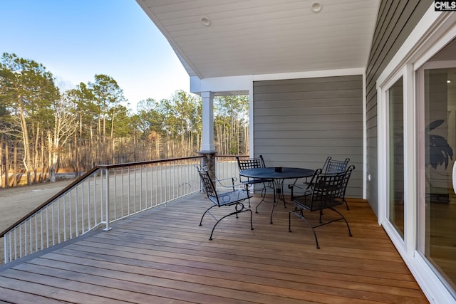 wooden terrace with outdoor dining area