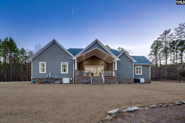 view of front of home with covered porch and central AC unit