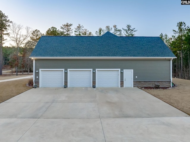 garage with concrete driveway