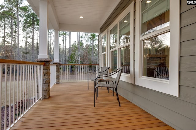 wooden terrace featuring covered porch