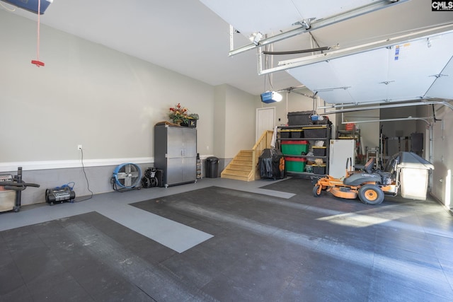 garage featuring freestanding refrigerator and a garage door opener