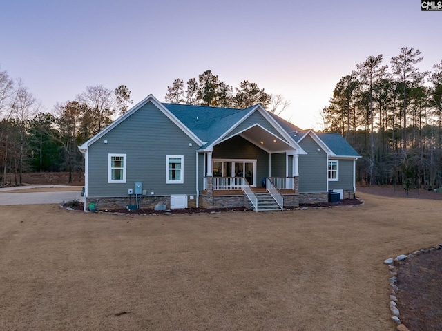 view of front of home with a porch and cooling unit