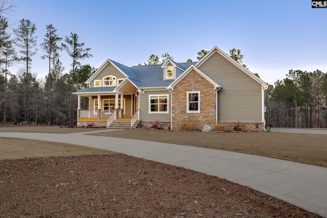 craftsman-style house with stone siding and covered porch