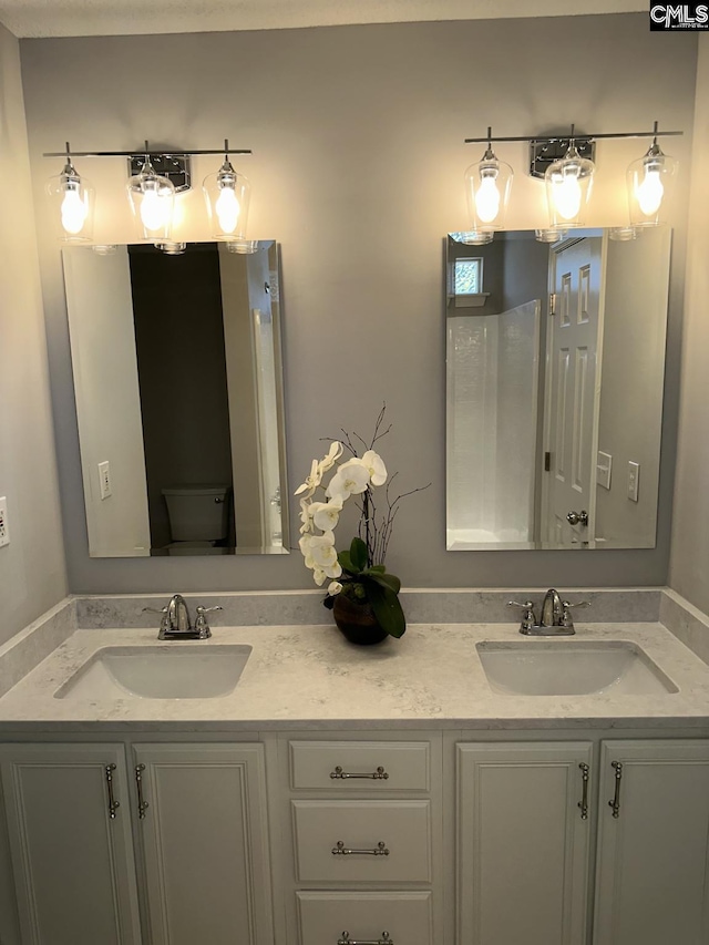 bathroom featuring vanity and toilet