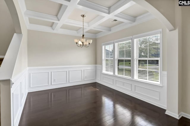 unfurnished dining area with beamed ceiling, coffered ceiling, a chandelier, and dark hardwood / wood-style flooring