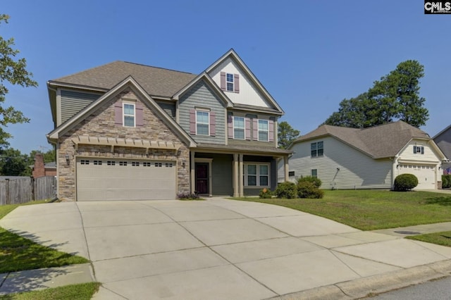 craftsman house with a garage and a front yard