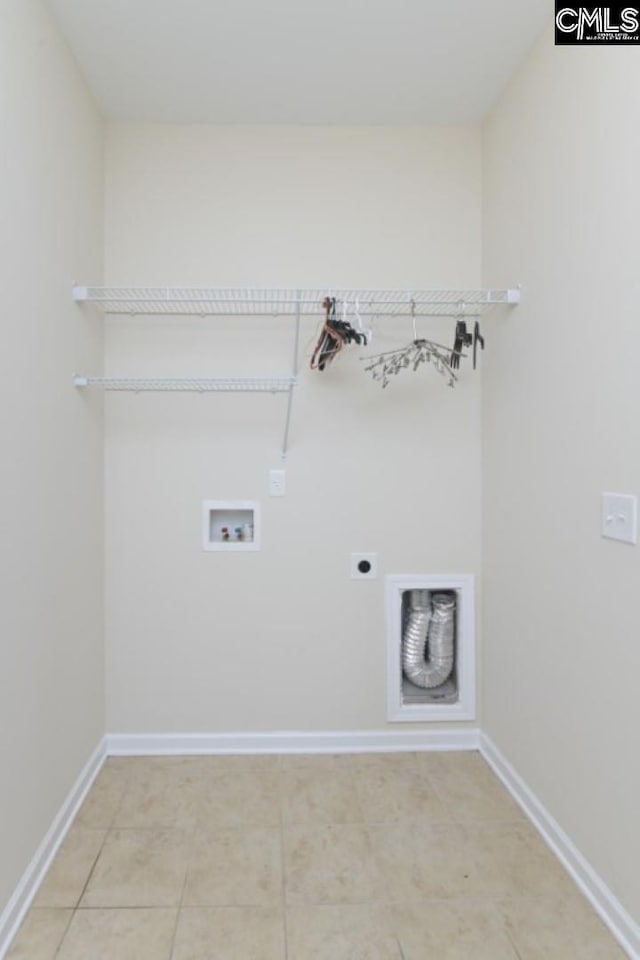 washroom featuring electric dryer hookup, hookup for a washing machine, and tile patterned floors