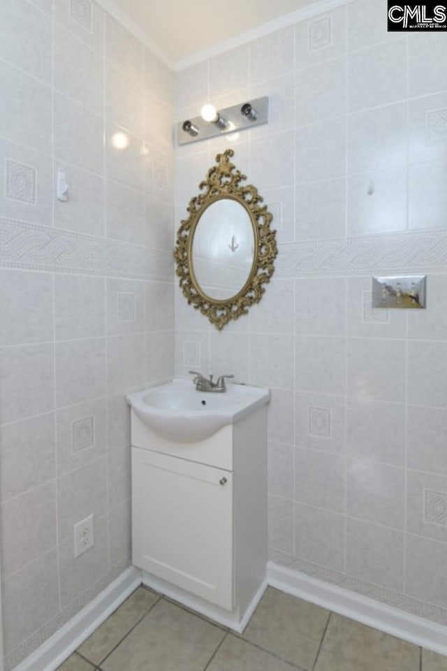 bathroom with tile patterned flooring, vanity, tile walls, and crown molding