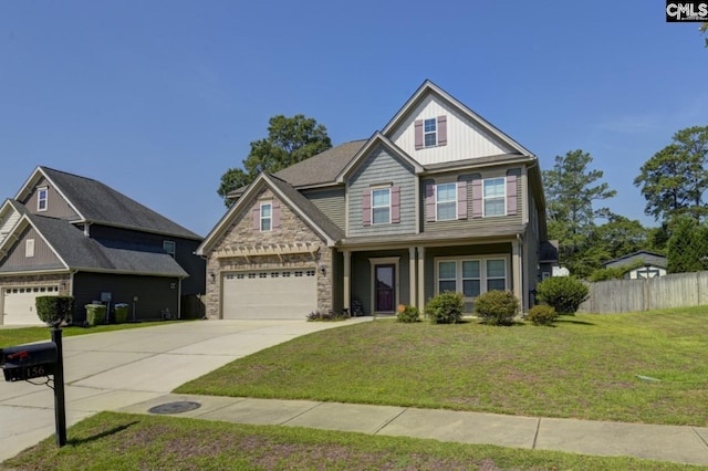 craftsman house with a garage and a front lawn