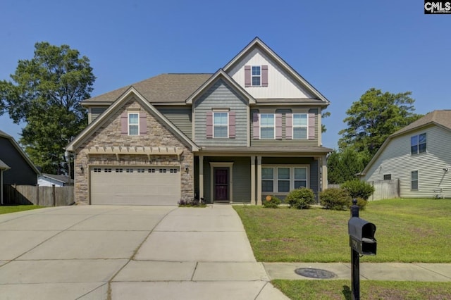 craftsman inspired home featuring a garage and a front lawn