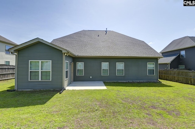 back of property featuring a yard and a patio area