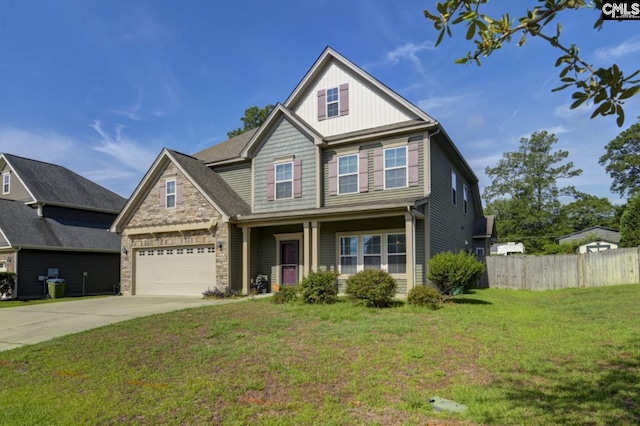 craftsman inspired home featuring a garage and a front lawn