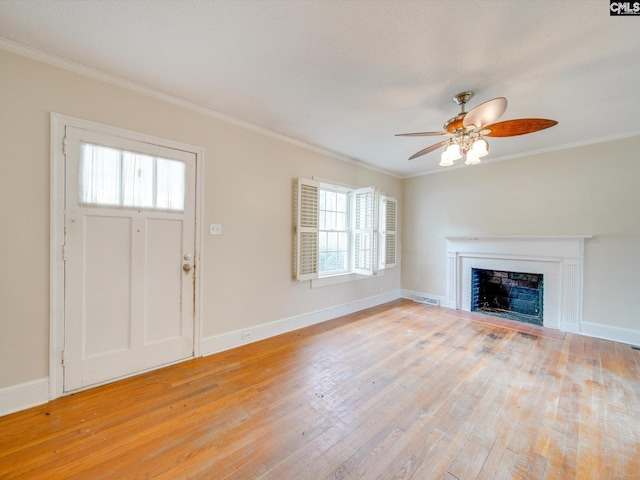 foyer entrance featuring ceiling fan, ornamental molding, and light wood-type flooring