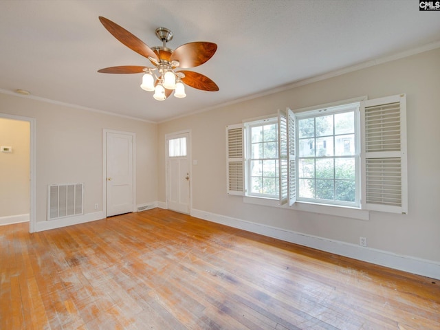 spare room with crown molding, ceiling fan, and light wood-type flooring