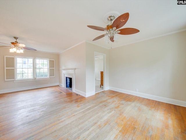 unfurnished living room featuring ornamental molding, ceiling fan, and light wood-type flooring