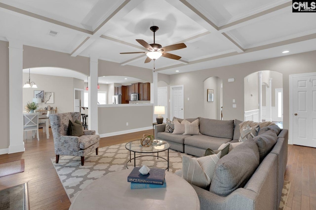 living room featuring beamed ceiling, ceiling fan, coffered ceiling, and light hardwood / wood-style floors