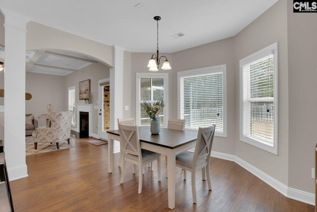 dining area with hardwood / wood-style floors and a notable chandelier